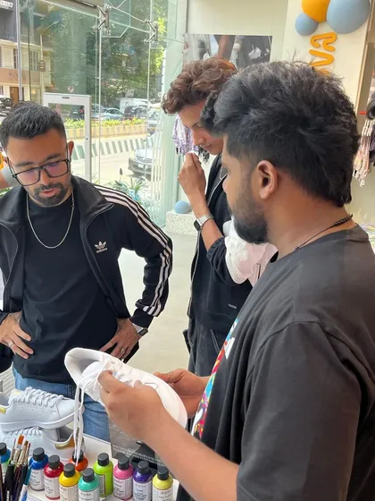 Collaboration is key. Here, we're discussing design ideas directly with customers at our live art station. This personal interaction ensures every person walks away with a custom piece they truly love.