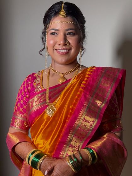 The complete look, showcasing the beautiful harmony between the makeup, the rich saree, and the traditional green bangles of a Marathi bride.