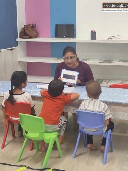 Here, I'm explaining the concept of binary to a small group of young learners using simple black and white cards. This method demystifies a complex topic and makes it accessible and understandable for kids.