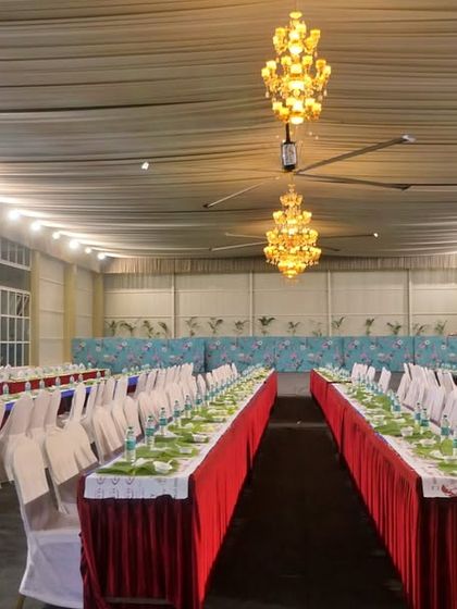 An empty hall prepared for a grand feast. This showcases the scale and precision of our setup for large events at venues like Palace Grounds.