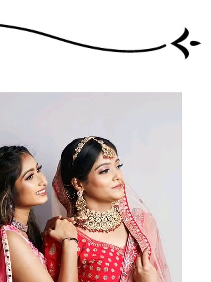 A beautiful moment between a bride and her best friend. The bride is wearing a classic red lehenga with a heavy choker set, all from our rental collection.