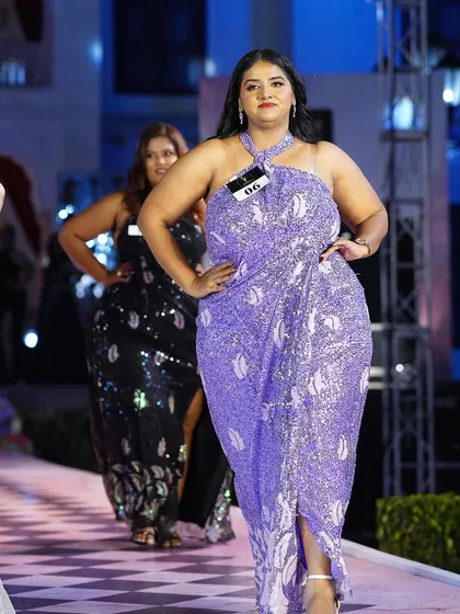 The lavender sequined plus-size gown making its way down the runway. The confidence of the model is what brings the outfit to life.