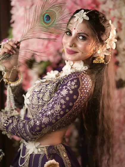 Adding a peacock feather, a symbol of Lord Krishna, to our Radha look.