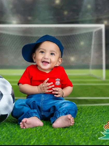For the future football star. This little Liverpool fan is all smiles on the pitch, ready for his first big game.