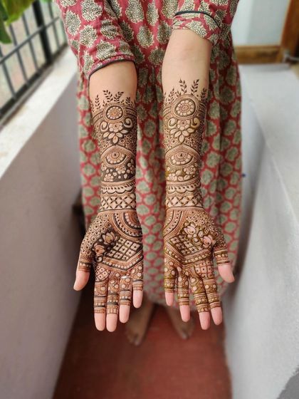 A full view of a mature bridal stain, showing the consistent dark color from the palms to the forearms.