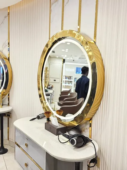 Our styling stations are where the magic happens. Each station features a beautifully lit, gold-framed mirror and all the professional tools needed to create your perfect look.