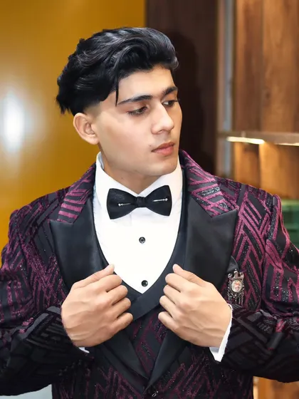 Adjusting the waistcoat on this purple patterned tuxedo. A three piece suit requires precise layering to look its best.
