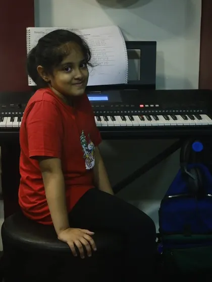 A student sitting at her keyboard, ready for her lesson to begin. We provide a welcoming environment for students of all ages.