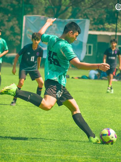 A player takes a powerful shot, demonstrating excellent kicking technique.