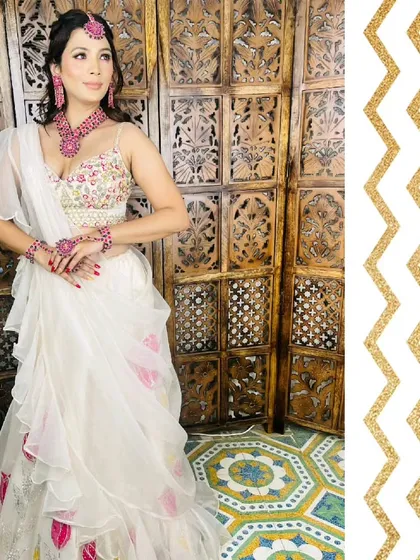 This white Indo-Western lehenga with a ready-to-wear ruffle dupatta is perfect for a haldi or mehendi function. The pop of pink from the jewellery adds a beautiful contrast.