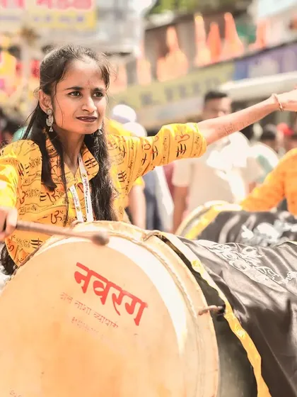 The color version of the focused female dhol player.