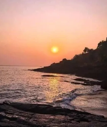A peaceful sunset over the rocky shores of Gokarna, a perfect moment of tranquility.