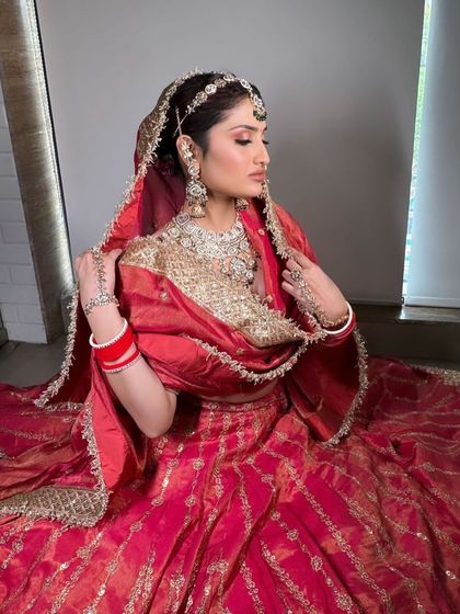A series of a bride in a traditional red and gold silk lehenga. The poses and styling are perfect for creating a classic, timeless bridal album.