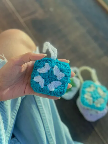 This bright turquoise pouch is decorated with a delicate white butterfly pattern. It’s a great example of how I can customize your gadget pouch with different motifs and color schemes.