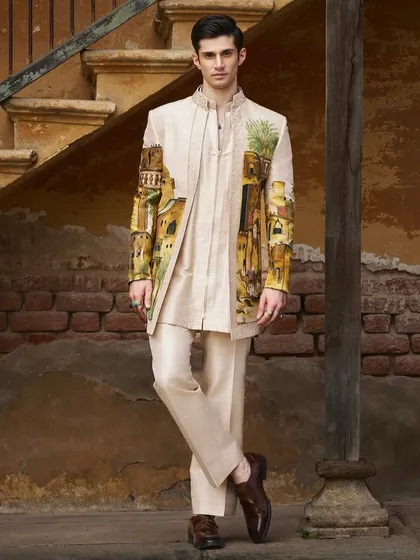 This hand-painted sherwani captures the essence of an Arabian desert landscape. Created in collaboration with Jayesh and Kajal Shah, the artwork wraps around the garment, telling a story of ancient architecture and serene palms.