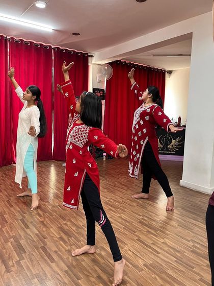 Dancers moving across the floor during a semi classical class. This style often involves dynamic and flowing transitions between different poses.