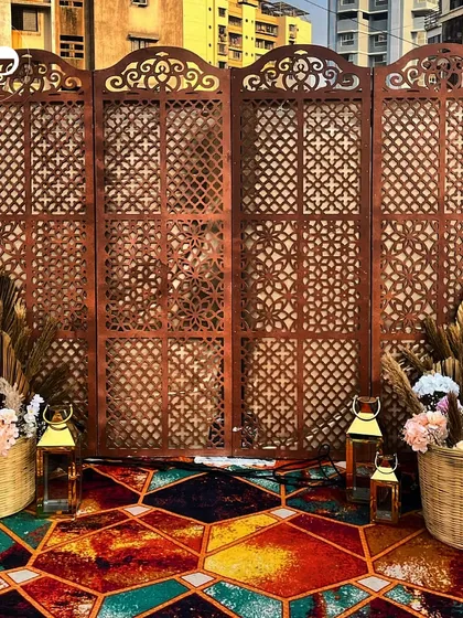 A glimpse into a chic Mehendi ceremony with a boho theme. We used a rustic carved wooden screen, pampas grass, and a vibrant geometric carpet to create a stylish and relaxed atmosphere for the celebration.