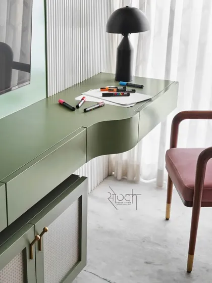 A custom study table integrated with a TV unit, featuring an artful curve to maximize maneuverability in a compact space.