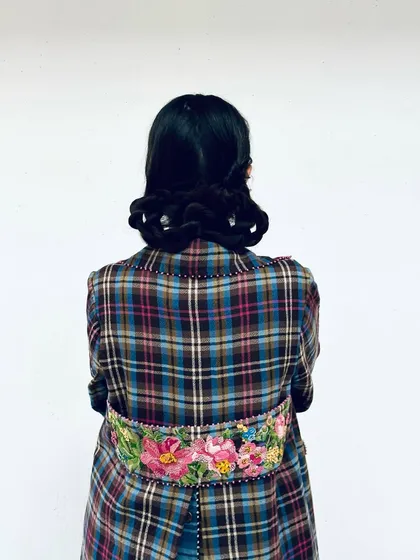 A detail shot of the back of this Pero coat, showcasing the beautiful floral embroidery that makes it so special.