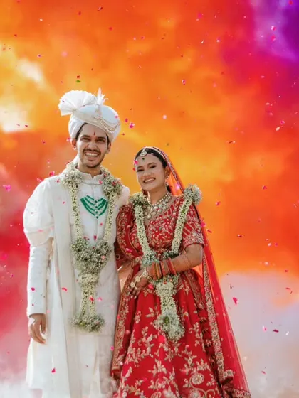 A vibrant explosion of color frames the couple, creating a stunning and modern portrait on their wedding day. This shot combines tradition with a contemporary, artistic flair.