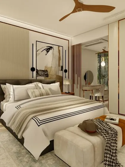 A bright and airy bedroom with clean lines and a neutral palette. We used black and white striped bedding and abstract art as accents, with a large wardrobe providing ample storage. A small vanity area is visible in the background.