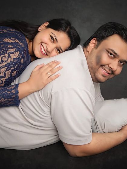 A creative and loving family portrait with a newborn. This pose is a fun way to include the whole family while keeping the baby safe and comfortable on dad's back.