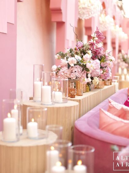 A beautiful composition of candles and florals at the 'Echoes of Pink' wedding. These details are the little hints and sneak peeks into who the couple is.