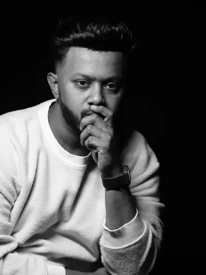 Success is not the key to happiness; happiness is the key to success. A pensive black and white portrait.