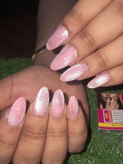 A close-up of these lovely pink glitter nails, showing the quality of our work on a simple, elegant design.