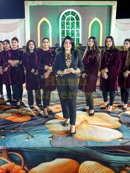 Our team of female servers in stylish velvet coats, ready to provide excellent service at a high-end event.