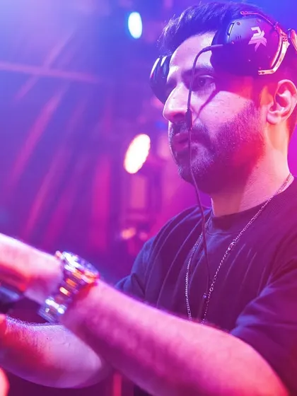 A focused shot of me at the console in Mauritius, with the stage lights creating a dynamic red and blue glow. Every festival set is a carefully crafted journey of sound.