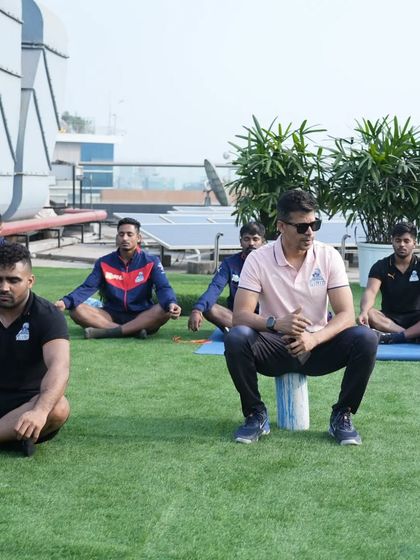 A wider view of the rooftop activation session. The team is focused and centered before the game.