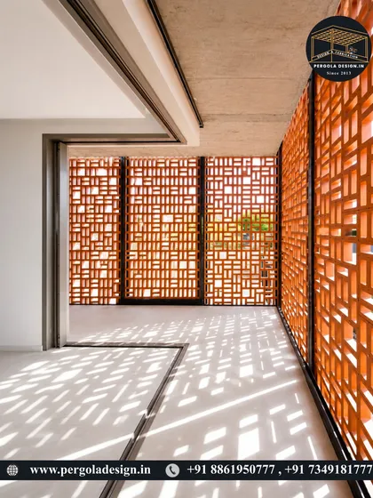 Sunlight streams through a terracotta jali wall, casting intricate shadow patterns on the floor. This demonstrates how jali screens can be used to create dynamic and beautiful light effects within a space.