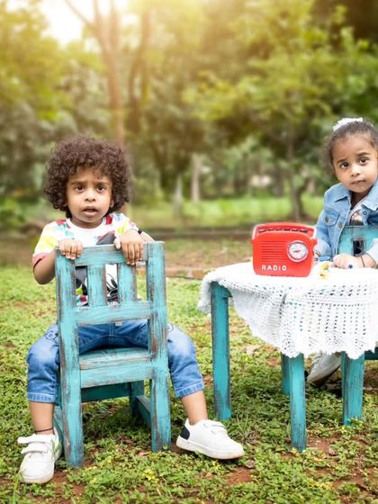 Twins having a little tea party in the park. I bring along props to create fun and interactive scenes for outdoor shoots.
