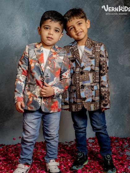 Brothers in blazers. This shot showcases two different but complementary printed blazers, perfect for coordinated looks at parties or events.