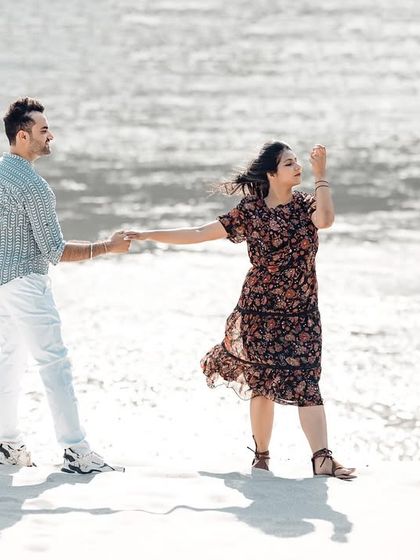 A playful "follow me" style shot on the bright, sandy banks of the river. The high-key lighting gives it a fresh and airy feel.