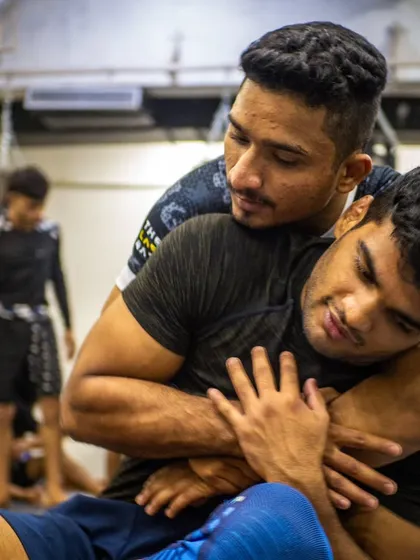 Drilling the rear naked choke, one of the most effective submissions in combat sports. Two of our students practice the technique during a seminar, focusing on the grip and body positioning needed to finish the fight.