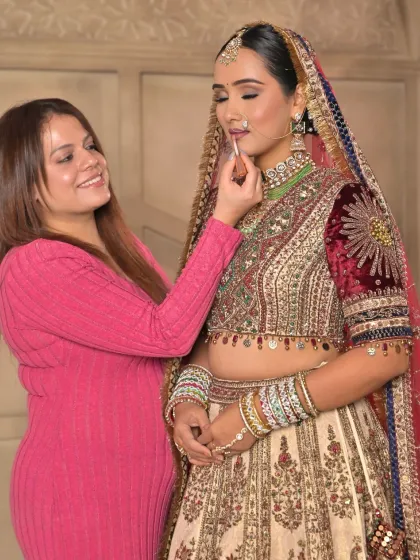 A personal moment as I apply the final touch of lipstick. I work closely with every bride to ensure her look is absolutely perfect.