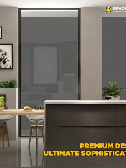 I design kitchens that integrate seamlessly with your living space. This layout features a kitchen island with an extended dining table, handleless dark wood cabinets, and a reflective glass panel that conceals storage for a clean, sophisticated look.