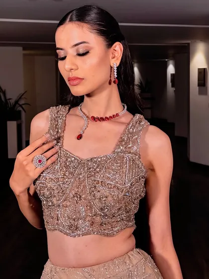 A softer expression of the same modern glam. This shot highlights the beautiful eyeshadow blend and the delicate ruby and diamond jewelry.
