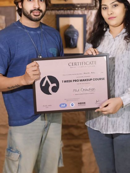 A happy student with her certificate after completing the one-week pro makeup course.