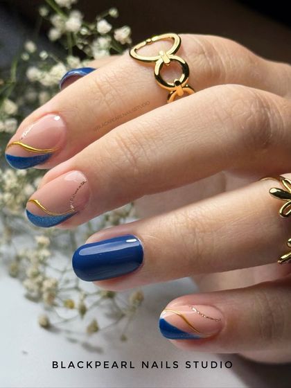 A sophisticated twist on the French manicure, this design features an ink blue glitter cat eye effect on the tips, accented with a delicate gold line. It’s a modern and luxurious look that combines multiple techniques.