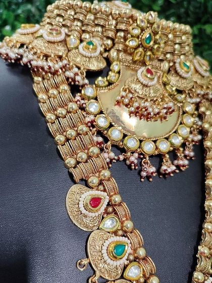 A closer view of the intricate motifs on this temple jewellery set, showing the craftsmanship in the choker and the pendant of the long necklace.