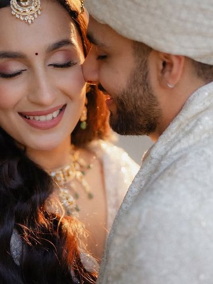 A close-up of a tender moment between the bride and groom. The soft, golden light and the genuine emotion make this a truly magical and unforgettable portrait from their Mumbai wedding.