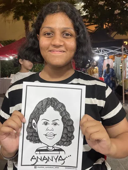 A young guest proudly displays her caricature at an event in R-City Mall, Ghatkopar.