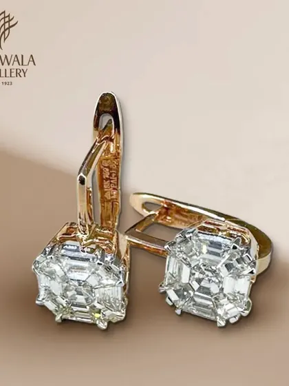 A close-up of the classic diamond huggie earrings, showcasing the quality of the illusion-set diamonds.