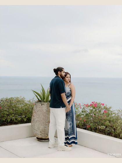 A quiet, contemplative portrait of the couple looking out at the ocean.