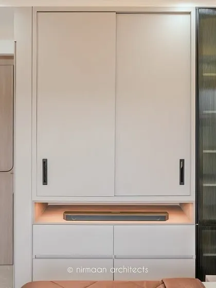 This bedroom at Sai World Empire features a custom wardrobe with an integrated soundbar niche. It's a perfect example of our bespoke furniture design that combines aesthetics with technology.
