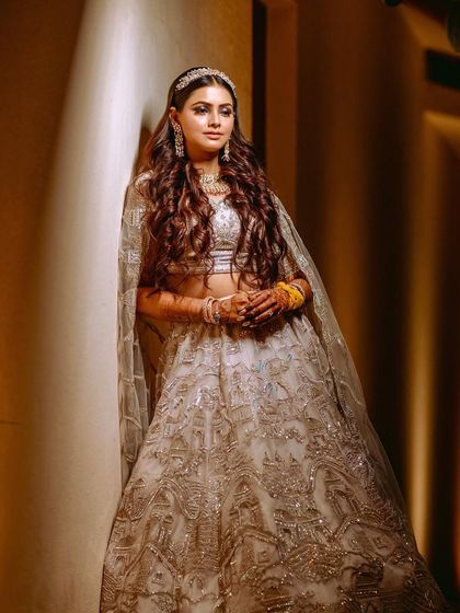 A beautifully lit portrait of the bride in a corridor, her elegant Sangeet outfit captured in full glory.