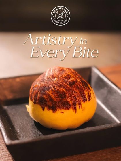 "Artistry in Every Bite." A single, beautifully crafted pastry with a burnished top, presented on a dark plate. Even the simplest dessert is treated like a work of art.